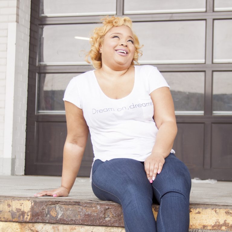 Portrait of Diana Veiga laughing on a doorstep